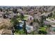 This aerial view showcases the well-maintained pool, tennis court and surrounding trees at 8752 E Amherst Dr # D, Denver, CO 80231