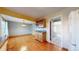 Bright dining area with seamless connection to the kitchen and a view of the carpeted living area at 8752 E Amherst Dr # D, Denver, CO 80231
