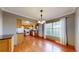 Sunlit dining area with wooden floors, elegant chandelier, and adjacent kitchen space at 8752 E Amherst Dr # D, Denver, CO 80231