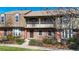 Charming two-story townhouse boasts a brick facade, balcony and a well-maintained front garden at 8752 E Amherst Dr # D, Denver, CO 80231