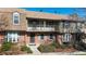 Charming townhouse with a brick facade, balcony, and a well-maintained front garden at 8752 E Amherst Dr # D, Denver, CO 80231