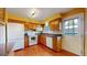 Functional kitchen with wooden cabinets, granite countertops, white appliances, and access to the backyard at 8752 E Amherst Dr # D, Denver, CO 80231