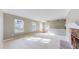 Bright living room with neutral walls and carpet, brick fireplace, and natural light at 8752 E Amherst Dr # D, Denver, CO 80231