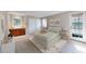 Spacious main bedroom with ensuite bathroom, door to outside and neutral color scheme at 8752 E Amherst Dr # D, Denver, CO 80231