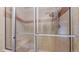 Tiled shower enclosure features glass doors, bench and shower head at 8752 E Amherst Dr # D, Denver, CO 80231