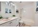 Bright bathroom featuring a shower-tub combo and a vanity with white cabinets and solid surface countertops at 16179 E Rice Pl # B, Aurora, CO 80015