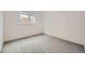 Carpeted secondary bedroom with a large window at 16179 E Rice Pl # B, Aurora, CO 80015