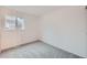 Carpeted secondary bedroom with a large window, offering natural light at 16179 E Rice Pl # B, Aurora, CO 80015