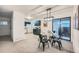 Open concept dining area with kitchen view and access to outdoor patio at 16179 E Rice Pl # B, Aurora, CO 80015