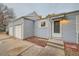 Exterior view of the home showing light blue siding, a front door, a two-car garage, and stone landscaping at 16179 E Rice Pl # B, Aurora, CO 80015