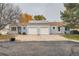 Low angle view of two single-story homes with a shared driveway, showing garages at 16179 E Rice Pl # B, Aurora, CO 80015