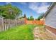 Large grassy backyard enclosed by a wooden fence and lush greenery, a nice outdoor space at 5275 Cody St, Arvada, CO 80002