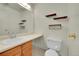 Clean bathroom featuring modern fixtures, a large mirror, and stylish shelving at 5275 Cody St, Arvada, CO 80002