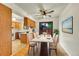 Bright dining area with wood floors, a ceiling fan, and sliding door access to the backyard at 5275 Cody St, Arvada, CO 80002