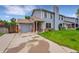 Charming home with a two-car garage, beautiful lawn, traditional siding, and brick accents at 5275 Cody St, Arvada, CO 80002