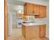Well-lit kitchen features white countertops, wood cabinets, and modern appliances at 5275 Cody St, Arvada, CO 80002