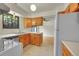 A sunlit kitchen with wooden cabinets and white countertops, including a view of the backyard at 5275 Cody St, Arvada, CO 80002