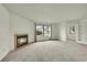 Bright, spacious living room featuring a fireplace, large windows, and neutral decor at 5275 Cody St, Arvada, CO 80002