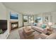 Bright living room features a cozy fireplace, large window, and neutral decor at 5275 Cody St, Arvada, CO 80002