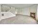 Bright living room with a fireplace, open staircase, and neutral carpet at 5275 Cody St, Arvada, CO 80002