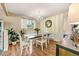 Cozy dining room with hardwood floors, chandelier lighting, and a classic striped accent wall at 11039 W 65Th Way, Arvada, CO 80004