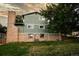 Back exterior view of the house, showcasing the brick foundation and siding at 11039 W 65Th Way, Arvada, CO 80004