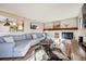 Comfortable living room featuring a fireplace, wood mantel, and a cozy sectional sofa at 11039 W 65Th Way, Arvada, CO 80004