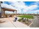 Beautiful backyard features a covered patio, manicured lawn, and scenic landscaping at 1616 Metcalf Dr, Erie, CO 80516