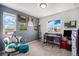 Comfortable bedroom features stylish decor, natural light, and a cozy sitting area at 1616 Metcalf Dr, Erie, CO 80516
