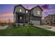 Charming two-story home with manicured lawn, two car garage, and tasteful modern gray color palette at 1616 Metcalf Dr, Erie, CO 80516