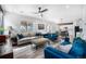 Spacious living room with hardwood floors, large windows for natural light, and comfortable seating arrangement at 1616 Metcalf Dr, Erie, CO 80516