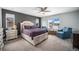 Inviting primary bedroom featuring a plush bed, stylish furniture, and plenty of natural light at 1616 Metcalf Dr, Erie, CO 80516