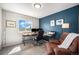 Home office featuring a modern desk, comfortable chair, and a serene view from the window at 1616 Metcalf Dr, Erie, CO 80516