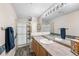 Traditional bathroom featuring a glass shower, wood-look floors, and a solid surface countertop with white sink at 5231 S Greens Cir, Littleton, CO 80123