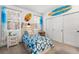 Bright bedroom featuring a large window, beachy décor and closet space at 5231 S Greens Cir, Littleton, CO 80123