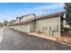Rear view of a modern apartment building with garage parking and a paved driveway at 5231 S Greens Cir, Littleton, CO 80123