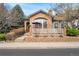 Charming home featuring stone accents, a cozy porch, and well-maintained landscaping at 5231 S Greens Cir, Littleton, CO 80123