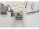 Hallway with sloped ceiling has gray carpet, fun decor, string lights, and a whiteboard with markers at 5231 S Greens Cir, Littleton, CO 80123