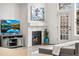 Cozy living room featuring a fireplace, entertainment center, and natural light at 5231 S Greens Cir, Littleton, CO 80123