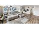 An expansive living area with modern decor and an open view to the kitchen at 5231 S Greens Cir, Littleton, CO 80123