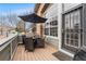Cozy patio with wood floors, dining table, wicker chairs, outdoor umbrella, and brick accents at 5231 S Greens Cir, Littleton, CO 80123