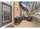 Relaxing covered patio with wood floors, wrought iron gate, and an outdoor grill at 5231 S Greens Cir, Littleton, CO 80123