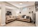 Basement area features a seating area with two sofas and a desk at 7708 S Krameria Ct, Centennial, CO 80112