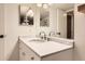 This bathroom has a white marble countertop with a sink, vanity mirrors, and white walls at 7708 S Krameria Ct, Centennial, CO 80112
