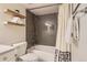 The bathroom has wood look shelving, a dark subway tile shower, and an elegant commode at 7708 S Krameria Ct, Centennial, CO 80112