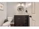 Powder room features a dark vanity with marble countertop, modern lighting, and a decorative mirror at 7708 S Krameria Ct, Centennial, CO 80112