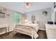 Cozy bedroom with natural light, a four-poster bed, a side table and décor at 7708 S Krameria Ct, Centennial, CO 80112