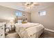 This bedroom has carpeted floors, white walls, natural lighting from the basement windows, and a metal frame bed at 7708 S Krameria Ct, Centennial, CO 80112