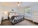 Light bedroom showcases a queen-sized bed, side table, and dresser at 7708 S Krameria Ct, Centennial, CO 80112