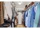 Walk-in closet featuring rods and shelves with hanging and folded clothing items, plus a white dresser at 7708 S Krameria Ct, Centennial, CO 80112